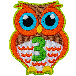An orange owl with big blue eyes stands at the ready. The number 3 is embroidered in green on the owl's chest.