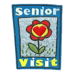A red flower framed between the words Senior Visit.