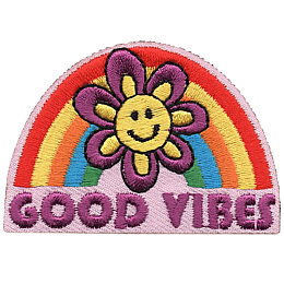 A smiling flower in front of a rainbow that reads Good Vibes.
