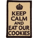The words Keep Calm And Eat Our Cookies on a light brown background.