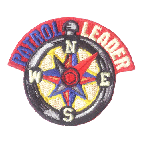 A compass with a red and blue star. The needle points northeast. The words Patrol Leader are around the top of the compass.