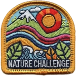 A patch depicting rolling hills with mountains in the background and leaves in the foreground.