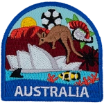 This patch displays a wide variety of Australian culture including: a kangaroo, they Sydney Opera House, a spider, a shark fin, a clown fish, the Great Barrier Reef, Ayers Rock, and a soccer ball/foot ball.