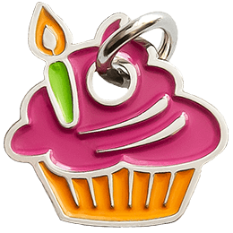 A cupcake with pink frosting and a lit green candle in an orange liner.