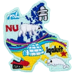 This patch is shaped like Nunavut with different symbols. Ice burg, an inukshuk, a polar bear, the aurora borealis, a snowmobile, a white beluga whale, and Iqaluit.