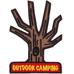 A tree without leaves, with the words Outdoor Camping, stitched in yellow on a red rectangle at the bottom.