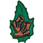 A pair of brown boots on a green leaf.