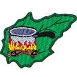 A pot over a fire on a green leaf.