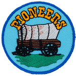 An old covered wagon sits under a heading that reads Pioneers.