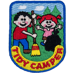 A boy and a girl work together to clean up their campsite and show that they are tidy campers.