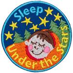 A child is tucked tight in a sleeping bag as they nap under a starry sky.