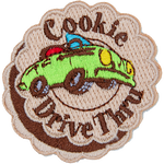A green convertible car with the words Cookie Drive Thru stitched on a patch made to look like a layered cookie.