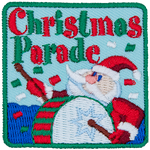 The words Christmas Parade are above a Santa Claus banging a drum.