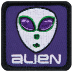 A classic alien head with big eyes and white skin on a purple background. The word Alien is below the head.