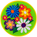 Four large flowers (a blue, an orange, a purple and a white one) are on a green background with tiny pink flowers in between them.