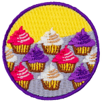 Cupcakes with pink, white and purple icing sit in three rows on a counter.