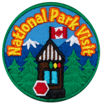 The words National Park Visit are above a park stop at the entrance to a forest with mountains. 