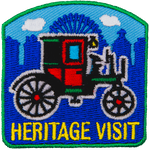 A red and green carriage above the words Heritage Visit.