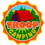 This round crest displays the text Troop Camping with a tent set up in a grassy field.