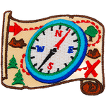 A compass is on top of a treasure map.