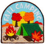 Autumn leaves fall on a tent and campfire, symbolizing fall camping.