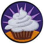A cupcake with white frosting against a purple background.
