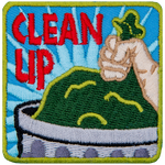 A hand places a garbage bag in a trash can. 