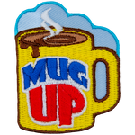 A mug is filled with steaming hot liquid.
