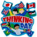 Three cheering people hold up flags of the world on the globe. The words Thinking Day are across the middle.