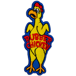 A yellow rubber chicken with a distressed face. The words Rubber Chicken are across its stomach.