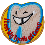 A winking tooth with the words I Lost My Tooth At Camp around the bottom in an arc.