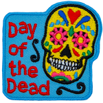 The words Day Of The Dead are next to a Calaveras.
