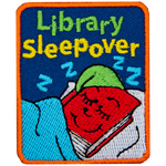 A red book with a green hat is tucked into bed. The words Library Sleepover is above it.