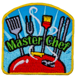 A spatula, fork, brush, and a set of tongs stand proudly over a steaming barbecue lid. The words ''Master Chef'' are embroidered over top of the utensils. 