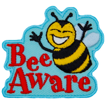A smiling bumble bee hovers over the words Bee Aware.