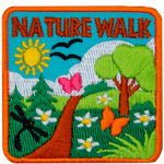 The words Nature Walk are above a green trail on a sunny day.