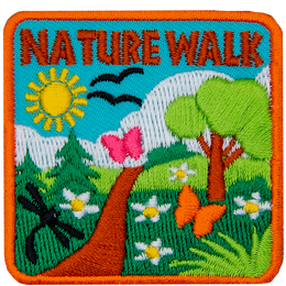 The words Nature Walk are above a green trail on a sunny day.