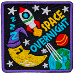 A rocket ship blasts off from the Earth next to a sleeping moon. The words Space Overnight are below the rocket.