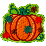 Green, red, and brown leaves rain down on a plump pumpkin still attached to the vine.