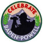 The words Celebrate Baden-Powell are around a silhouette of an explorer and a mountain range.