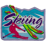 A pink skier is next to two crossed green skis. The word Skiing is across the middle.
