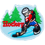 A hockey player skates on pond ice with evergreen trees in the background. The word Hockey is embroidered next to the player.