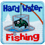 A fish frozen in an iceblock is pulled out of an ice fishing hole. The words Hard Water Fishing are above and below.