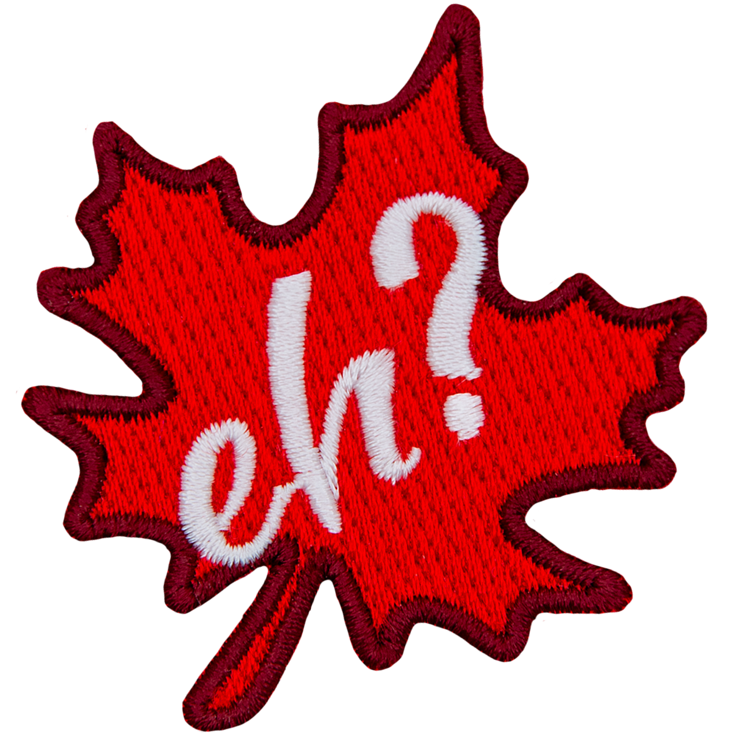 A red maple leaf sits at a fifteen-degree angle. The word Eh? is embroidered in white in the leaf's center.