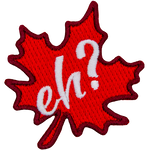 A red maple leaf sits at a fifteen-degree angle. The word Eh? is embroidered in white in the leaf's center.