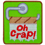 The words Oh Crap! are stitched on an empty toilet paper roll.