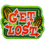 The words Get Lost are in a font made of arrows. Behind them are a corn maze and two ears of corn.
