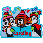 A penguin, a puffin and a beaver sing from a book in front of them. The word Caroling is at the bottom.
