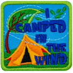 The words I Camped In The Wind are next to a yellow tent and a tree blown by the wind.