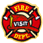 A fireman's hat sits on top of crossed axes, which itself is in front of the fire crest. The words Fire Visit Dept are down the middle.